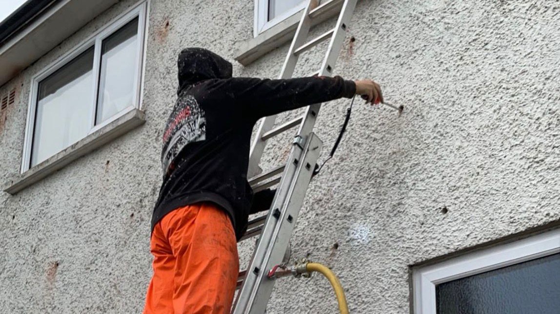 First Choice Energy installer drilling a cavity wall extraction on a South Wales property