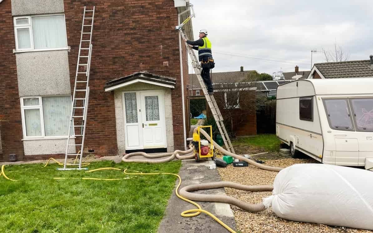 Engineer carrying out cavity wall extraction on a South Wales property