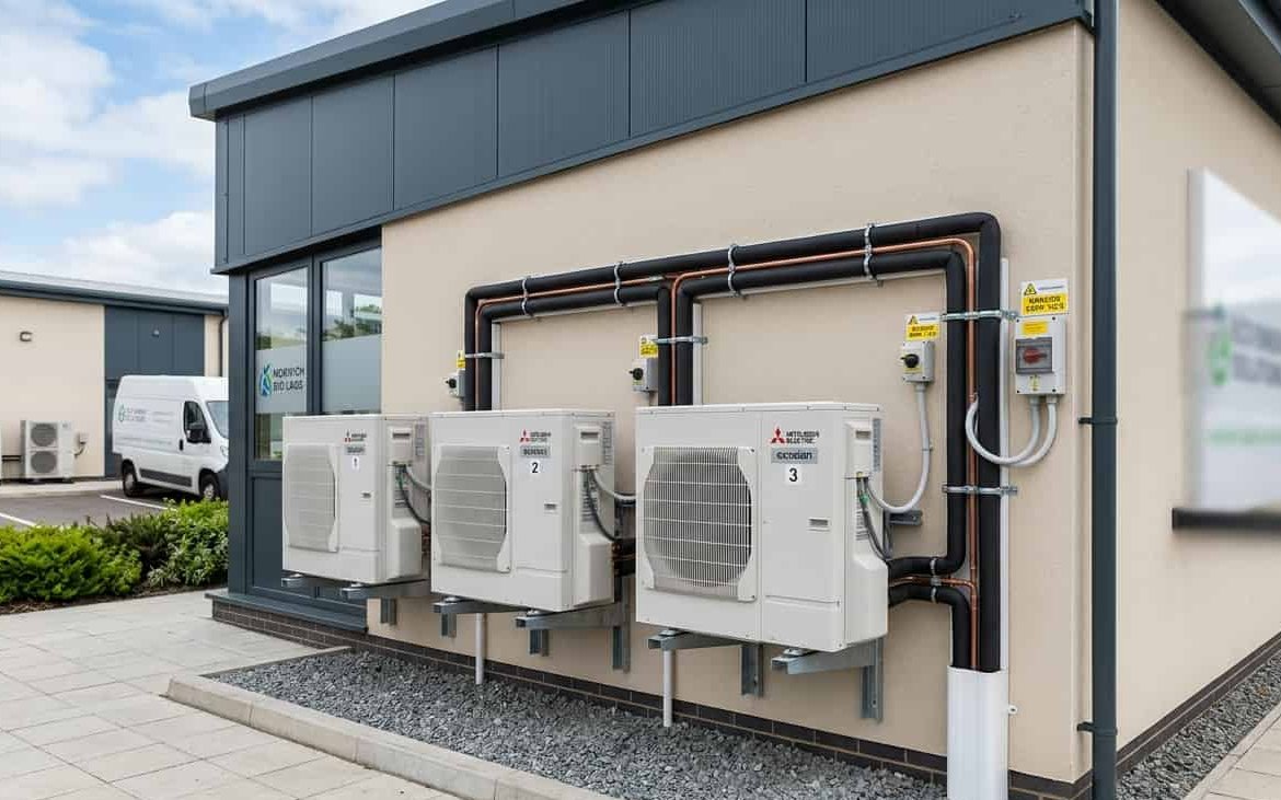 Multiple Mitsubishi commercial ASHP units installed on a business premises
